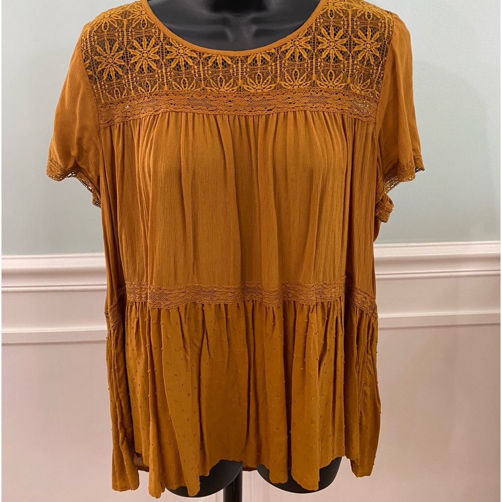 Yellow blouse with cutout details.